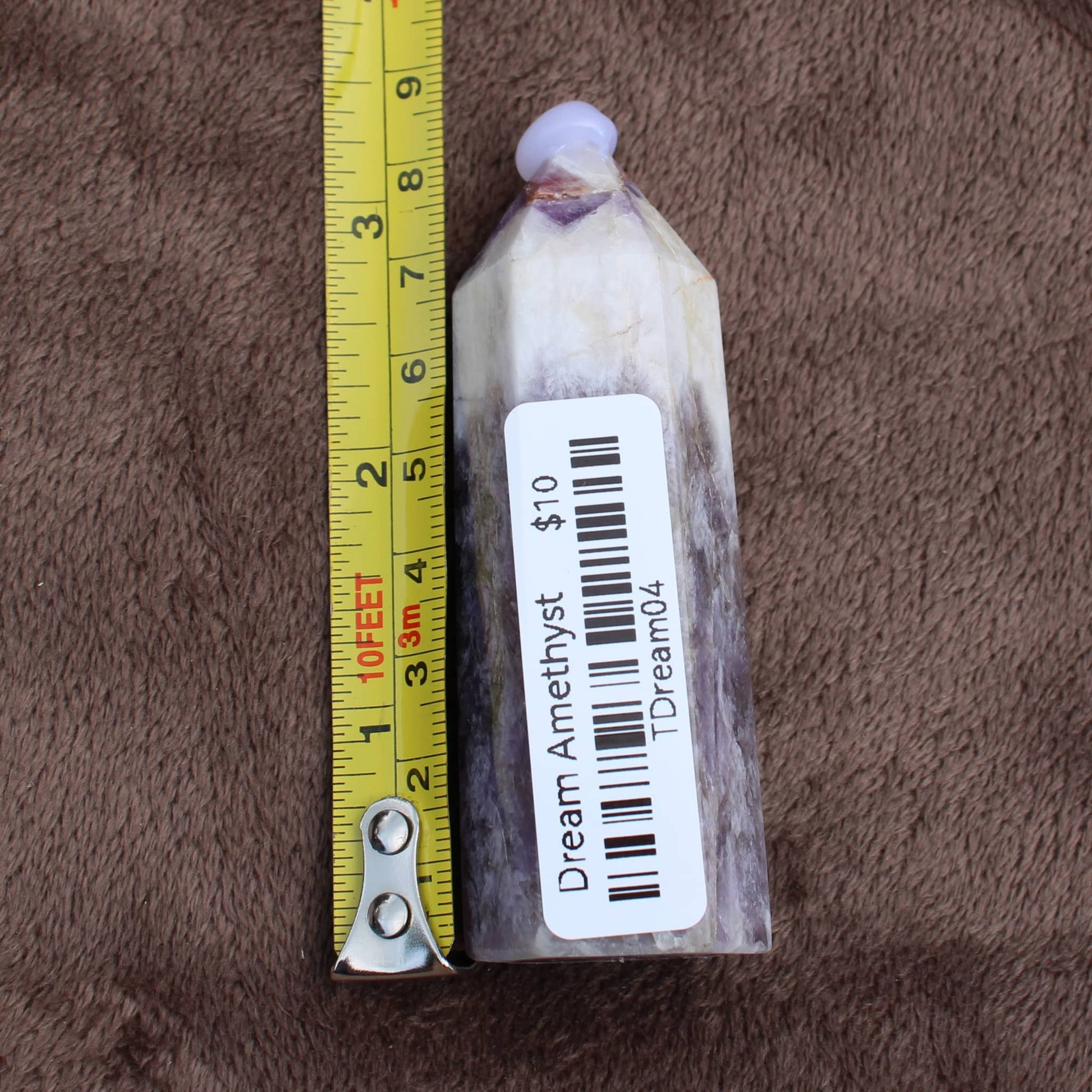 Dream Amethyst Tower crystal measuring about 3 inches tall with purple and white 