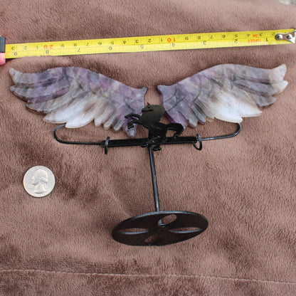 Dream Amethyst Unicorn Wings crystal decoration with metal stand showing size next to quarter and tape measure