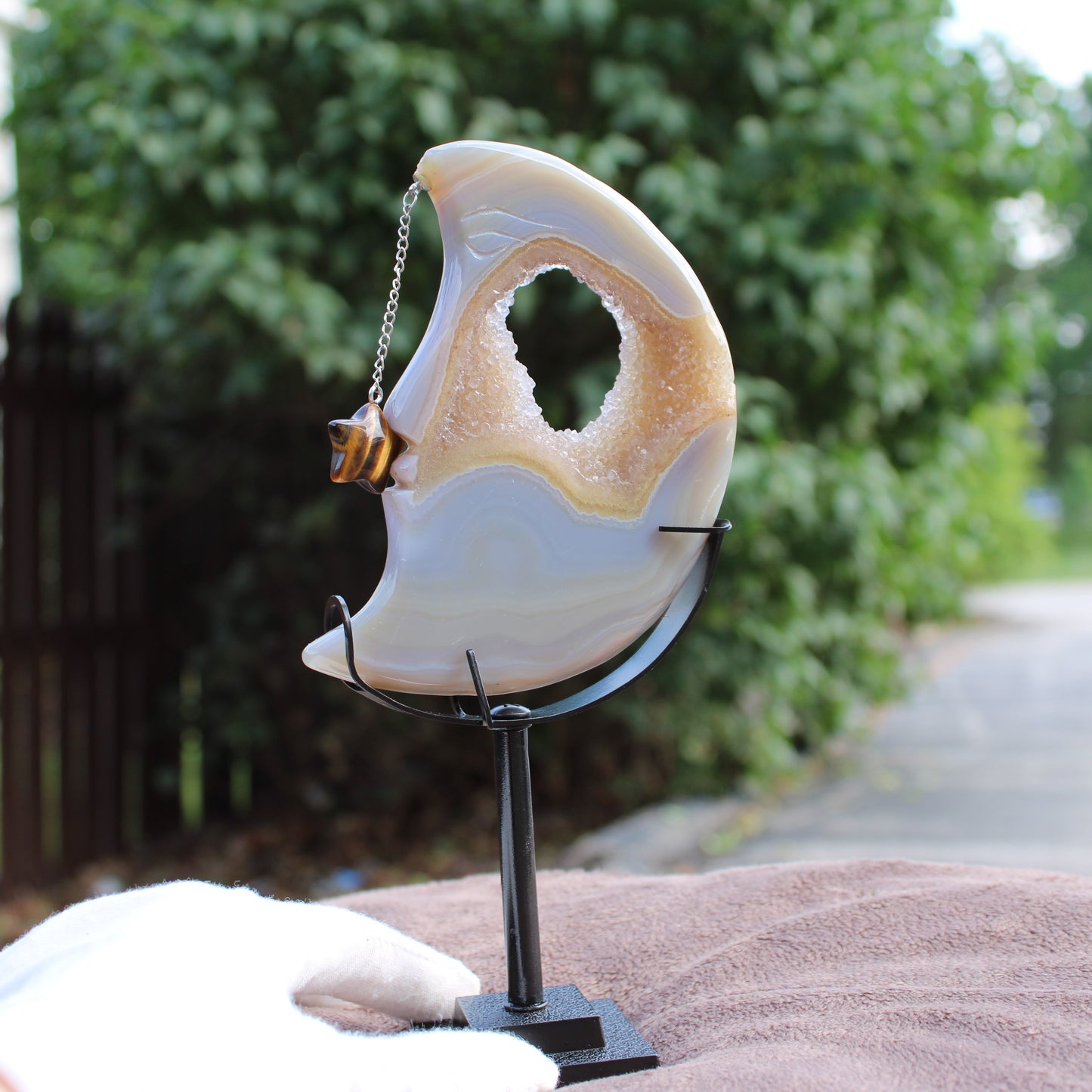 Druzy Agate Moon crystal on black metal stand with tiger eye charm by Different Branches LLC