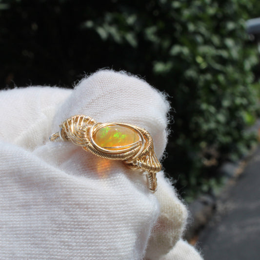 Ethiopian Opal Mixed Metal Ring displayed elegantly on a hand with a soft background