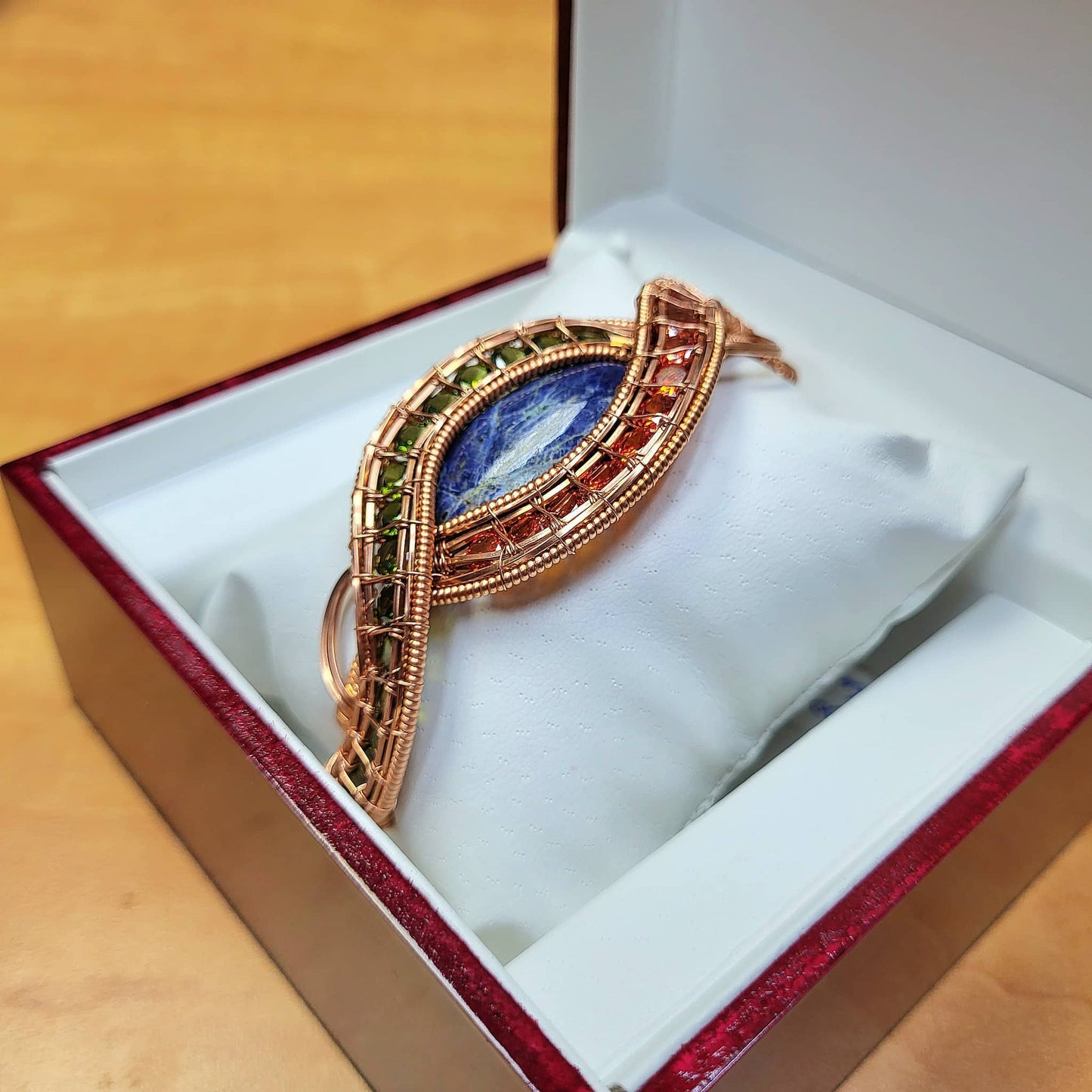 Elegant evil eye sodalite bracelet in a gift box with a copper wire design and vibrant colored accents