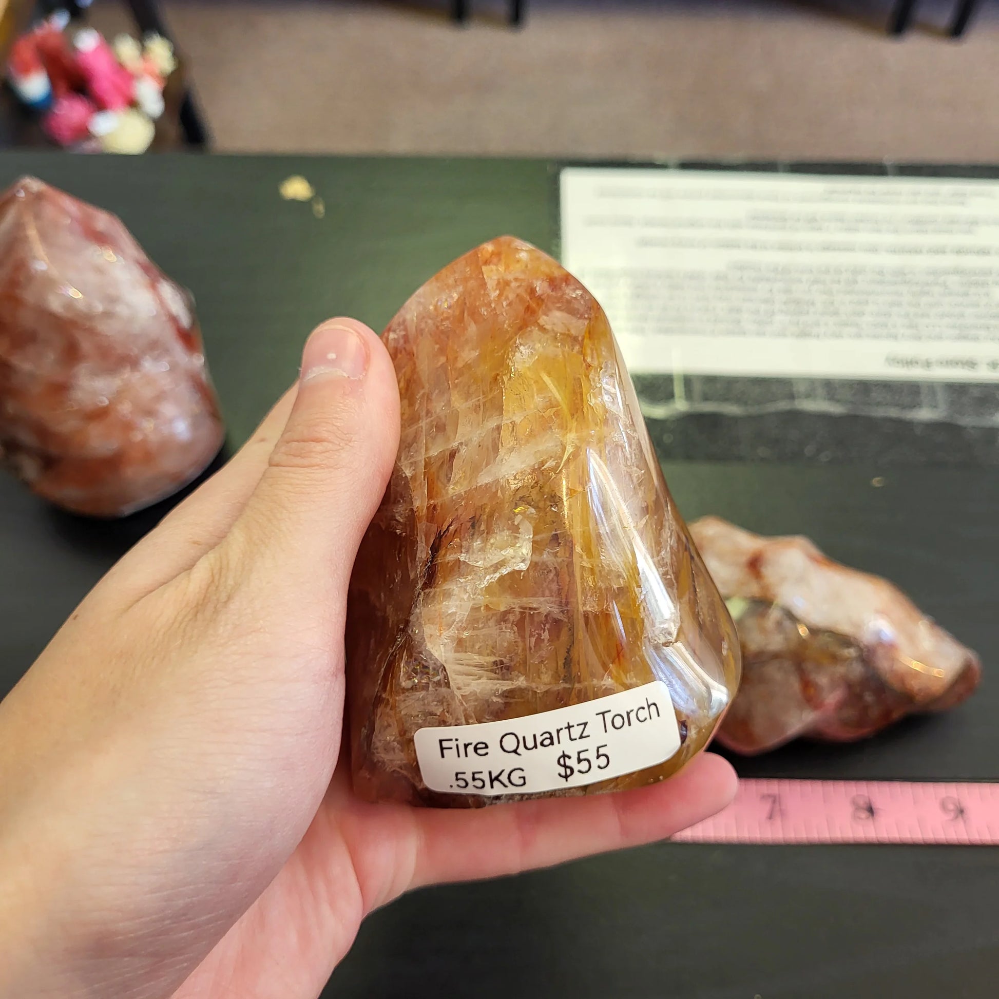 Person holding a fire quartz torch showcasing its natural beauty and golden hues
