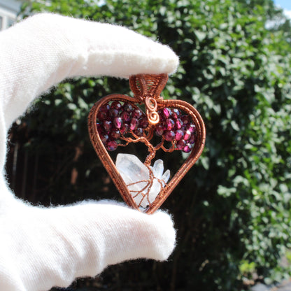 Handcrafted garnet heart tree of life pendant with crystal and copper wire detailing