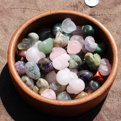 Assorted Gemstone Sugar Skull Carvings in a Round Wooden Bowl for Unique Home Decor