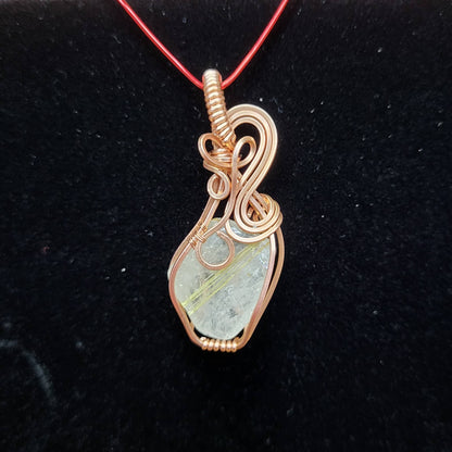 Handcrafted pendant featuring Gold Rutile Quartz wrapped in copper wire for a unique jewelry piece