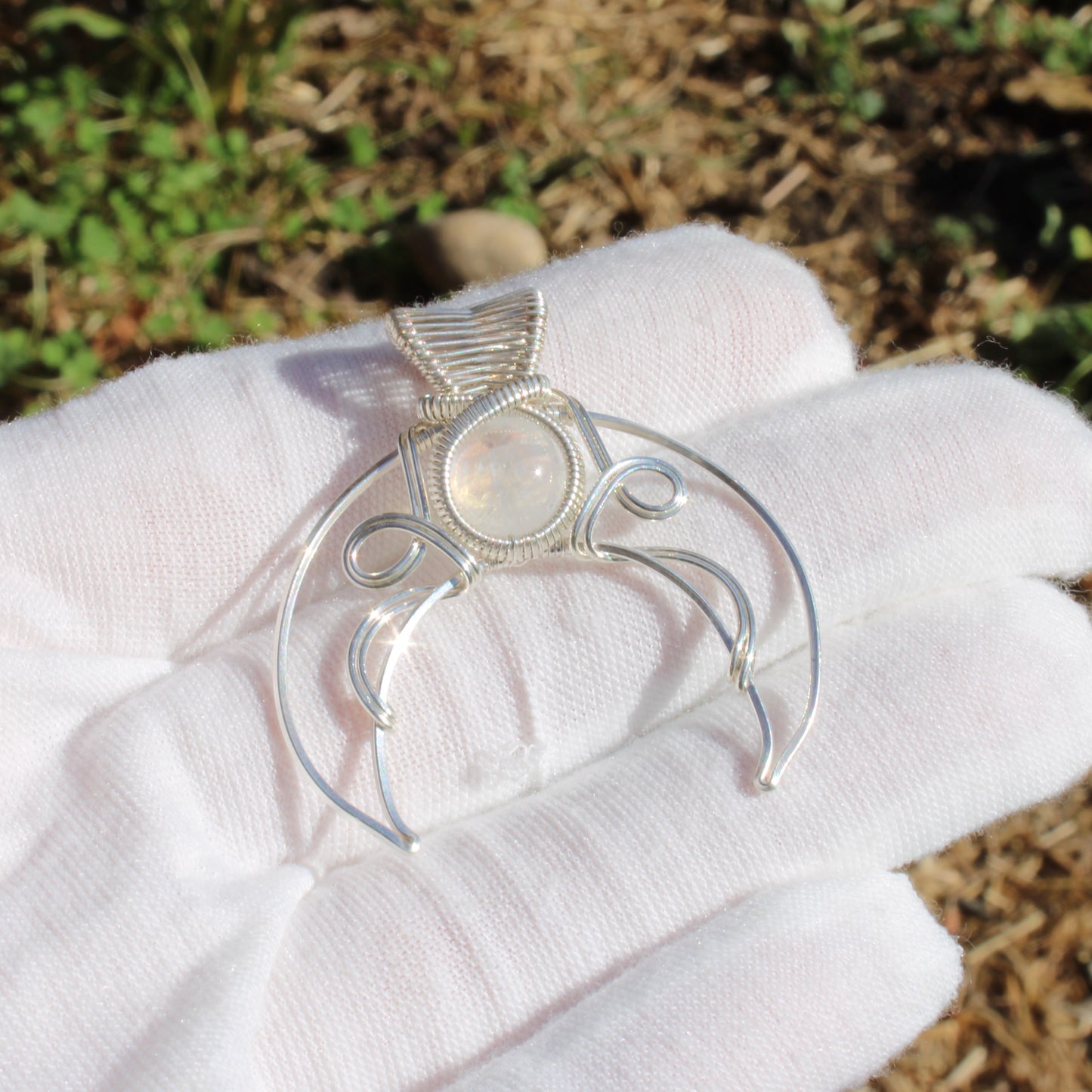 Jim Henson's Labyrinth sterling silver pendant with intricate wire design and luminous gemstone