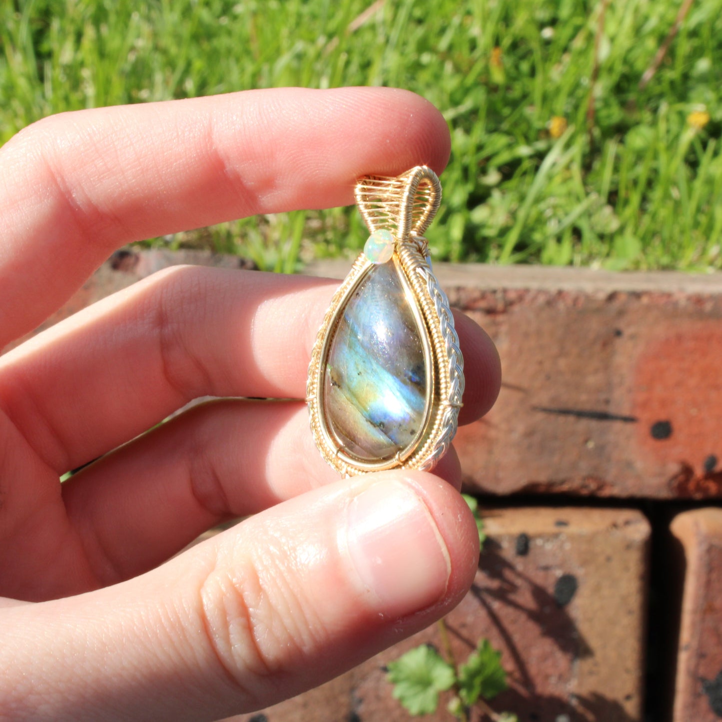 Hand holding Labradorite 14k Gold Fill and Sterling Pendant with iridescent colors, perfect for elegant jewelry lovers