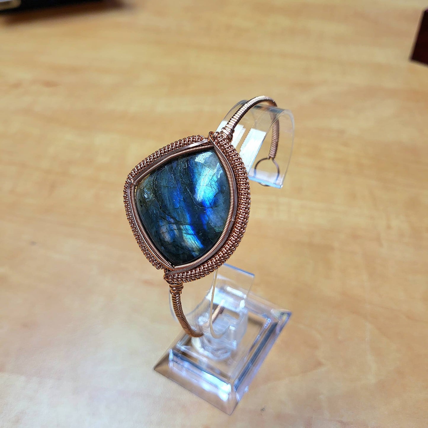 Labradorite big cabochon bracelet with copper wire wrapping showcasing iridescent stone details