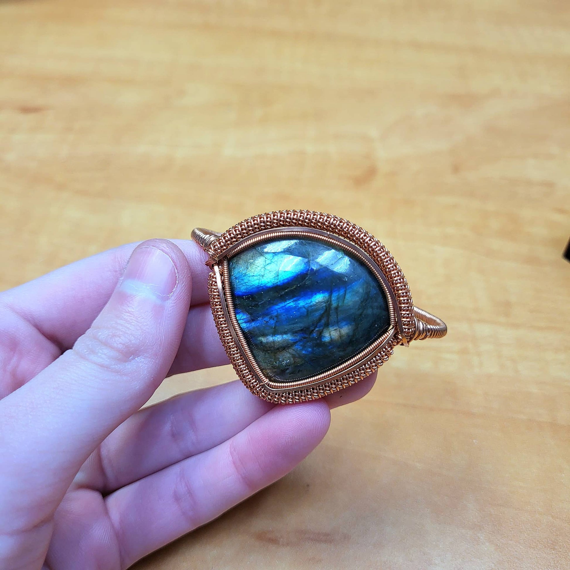 Labradorite big cabochon bracelet with intricate copper wire wrapping, showcasing a stunning blue flash.