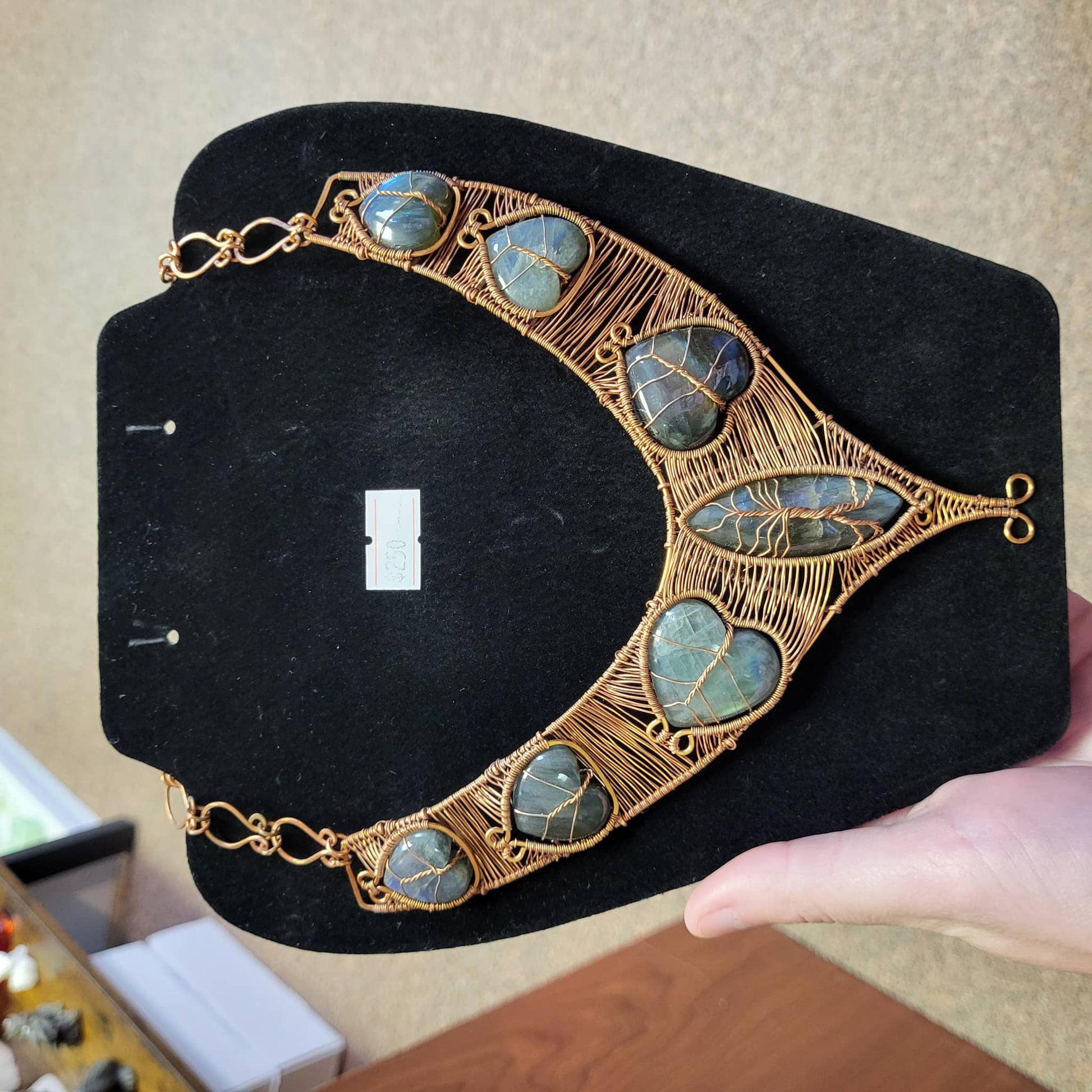 Labradorite copper bib necklace featuring intricate wire wrapping and unique gemstone designs