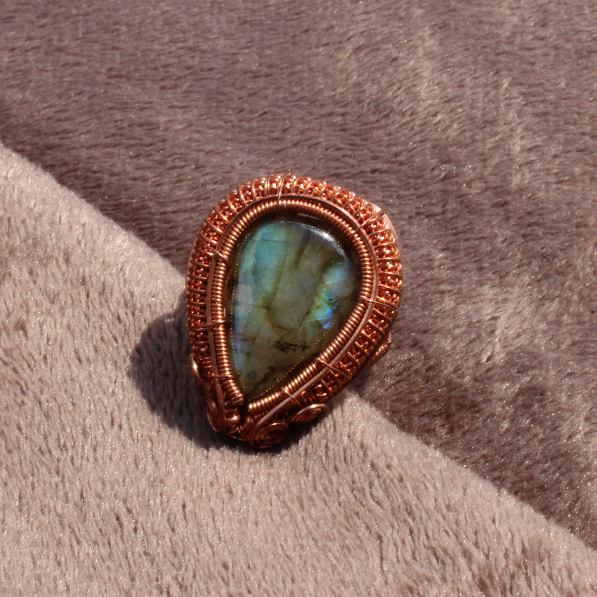 Handcrafted Labradorite Copper ring featuring a unique blue-green gemstone in an intricate design