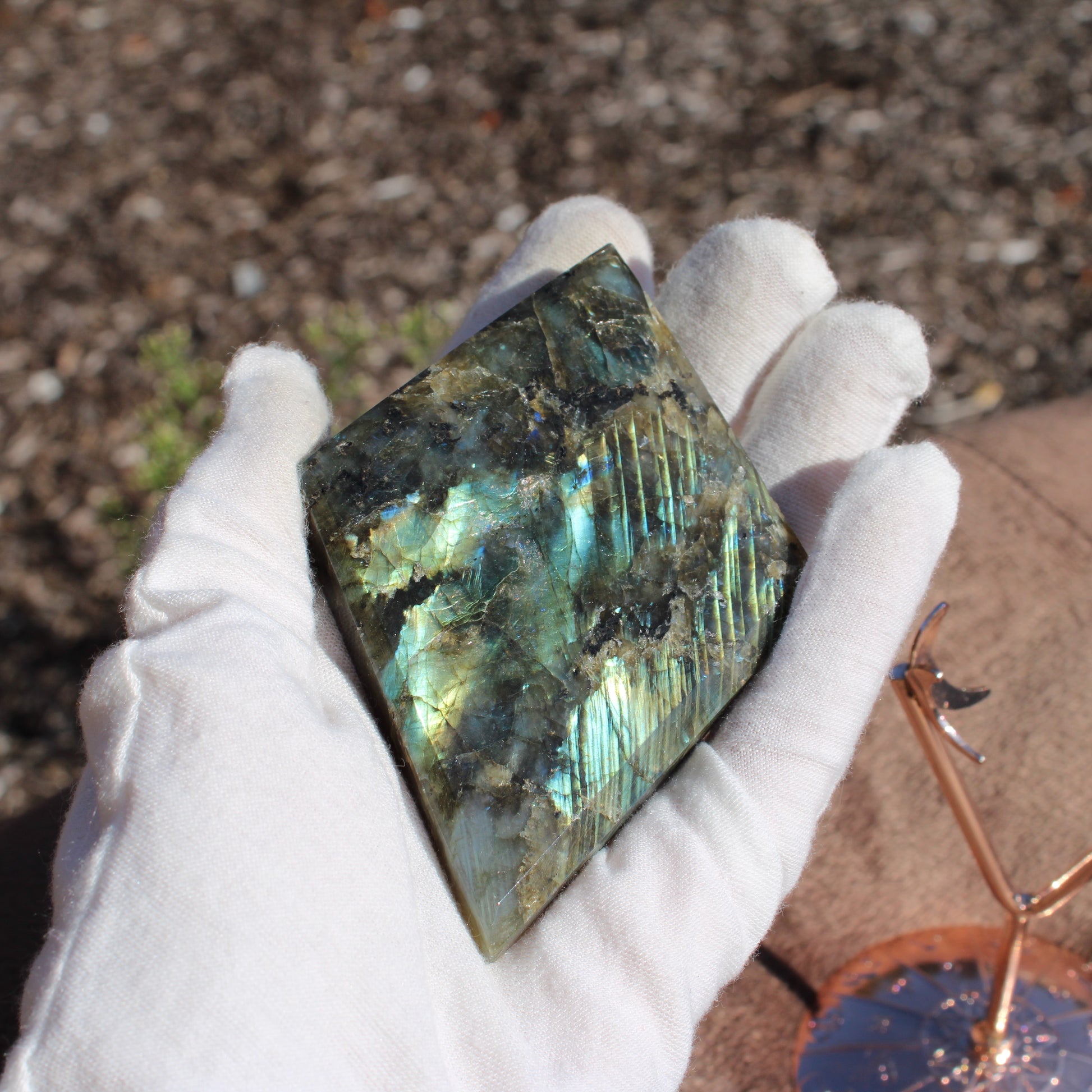 Labradorite Diamond Crystal in Hand with Iridescent Color Play for Decorative Purposes