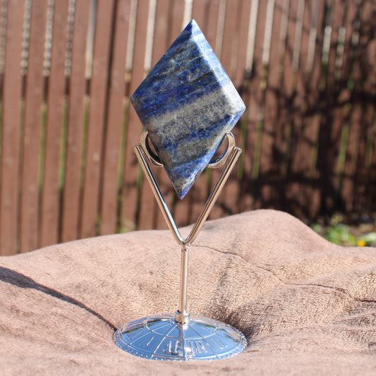 Lapis Diamond Crystal on a decorative stand showcasing its deep blue color and unique shape