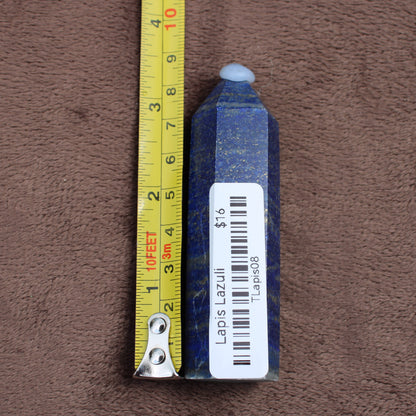 Lapiz Lazuli Tower crystal with deep blue color and gold flecks measured next to a tape measure
