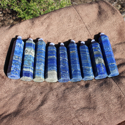 Lapis Tower Collection with multiple blue crystal towers arranged on a soft brown surface