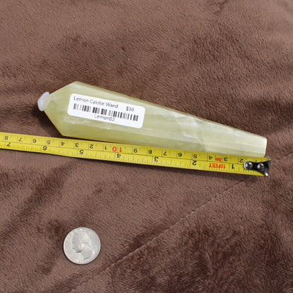 Lemon Quartz Wand crystal measuring about 6 inches with a price label from Different Branches LLC