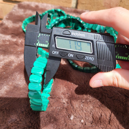 Measuring the diameter of a Malachite Bead bracelet with a digital caliper for precise sizing