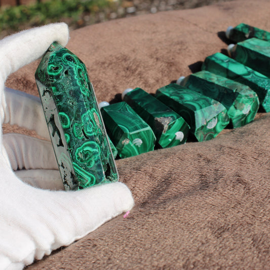 Malachite tower collection featuring polished stones in various shapes and sizes for home decor