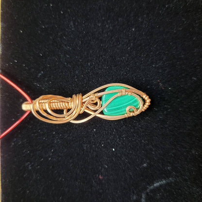 Handcrafted Malachite Pendant Wrapped in Gold Wire on a Red Necklace for Unique Jewelry Style