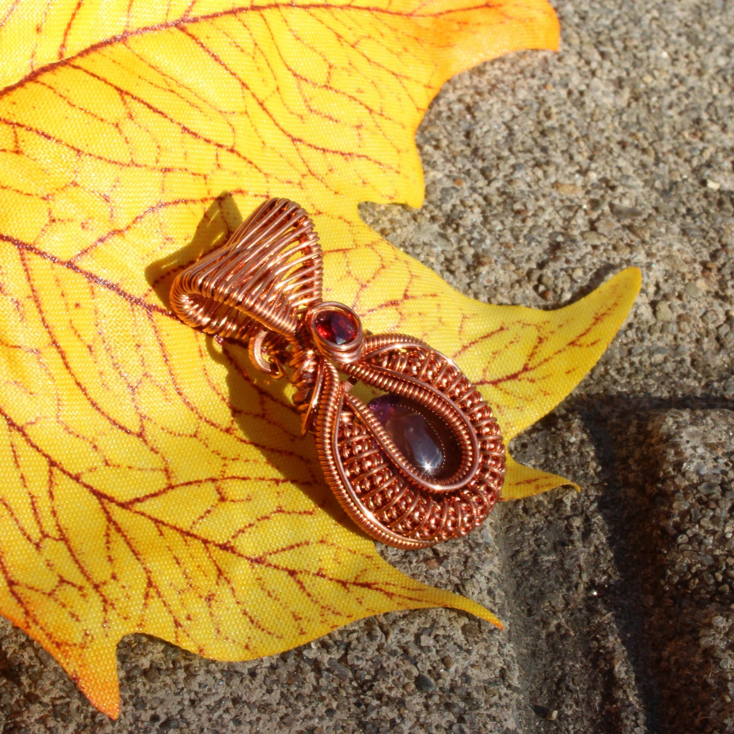 Mini amethyst copper pendant elegantly displayed on a colorful autumn leaf