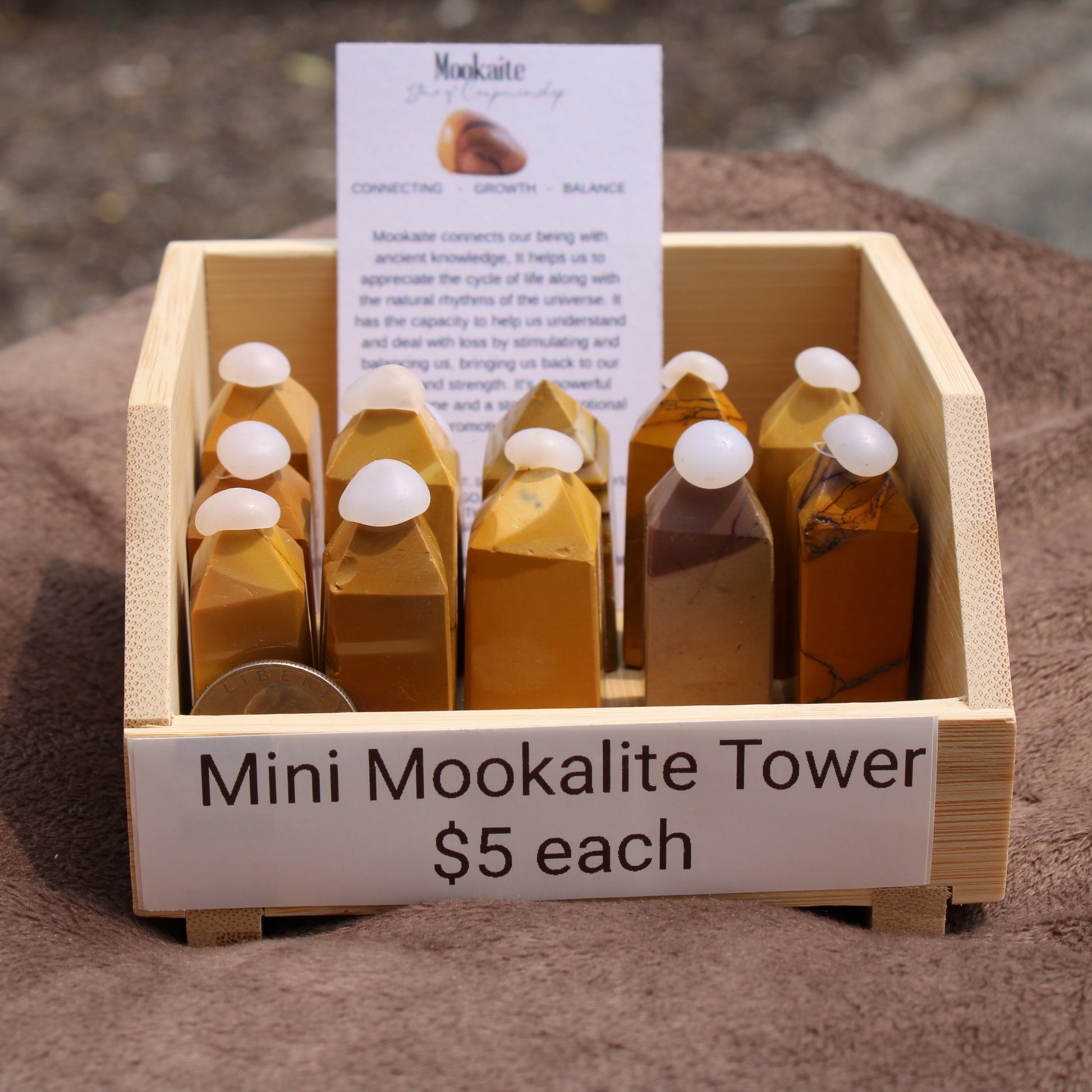 Mini Mookalite towers displayed in a wooden crate for sale at My Store, promoting balance and growth