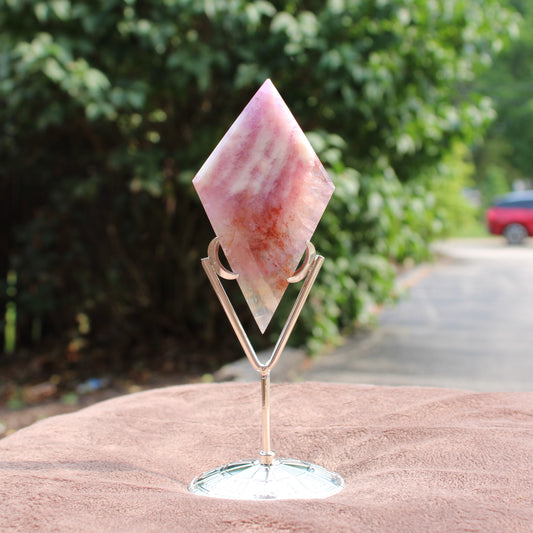 Mixed Quartz Diamond crystal with pink and orange hues on a metal stand by Different Branches LLC