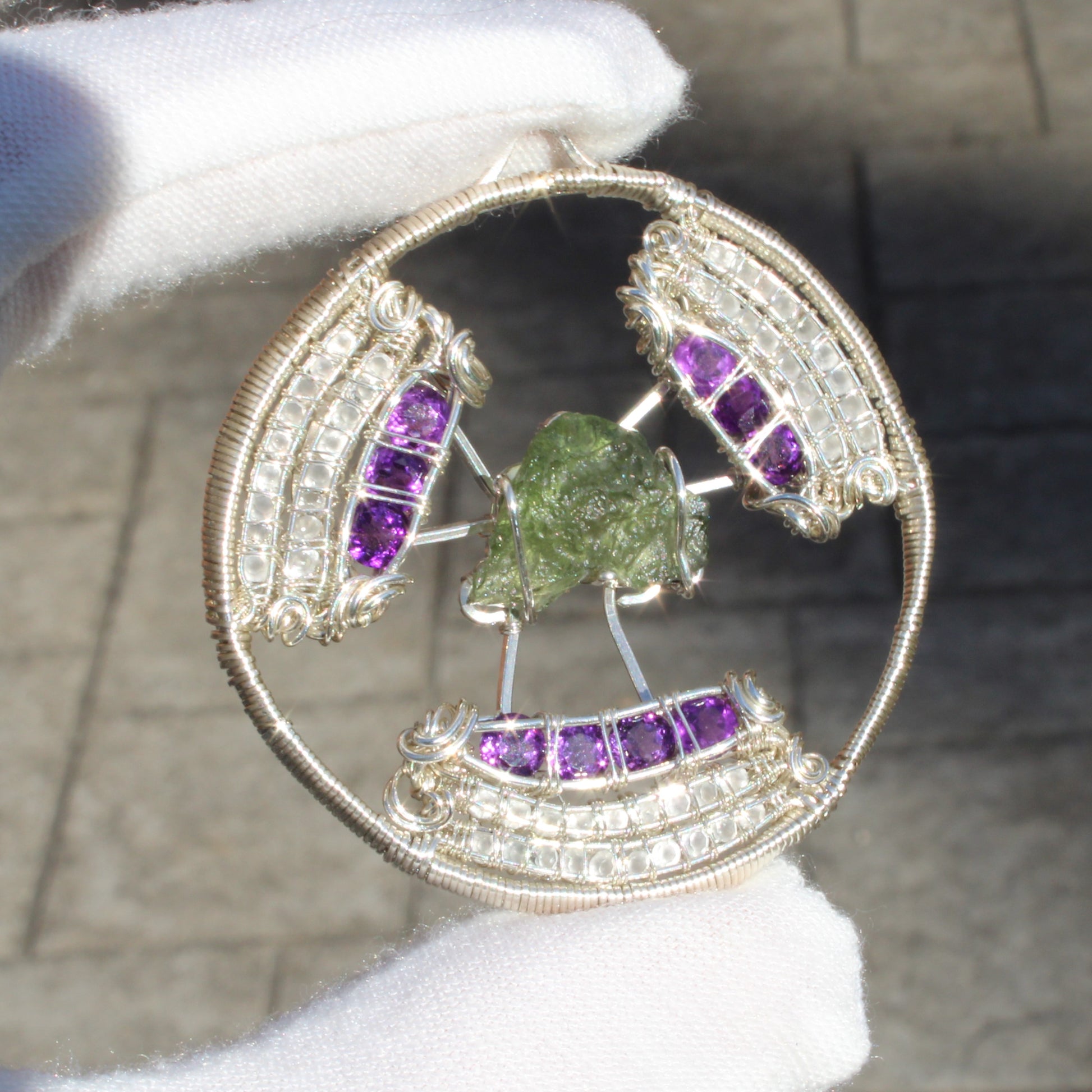 Handcrafted moldavite amethyst moonstone pendant with intricate wire detailing and vibrant gemstones