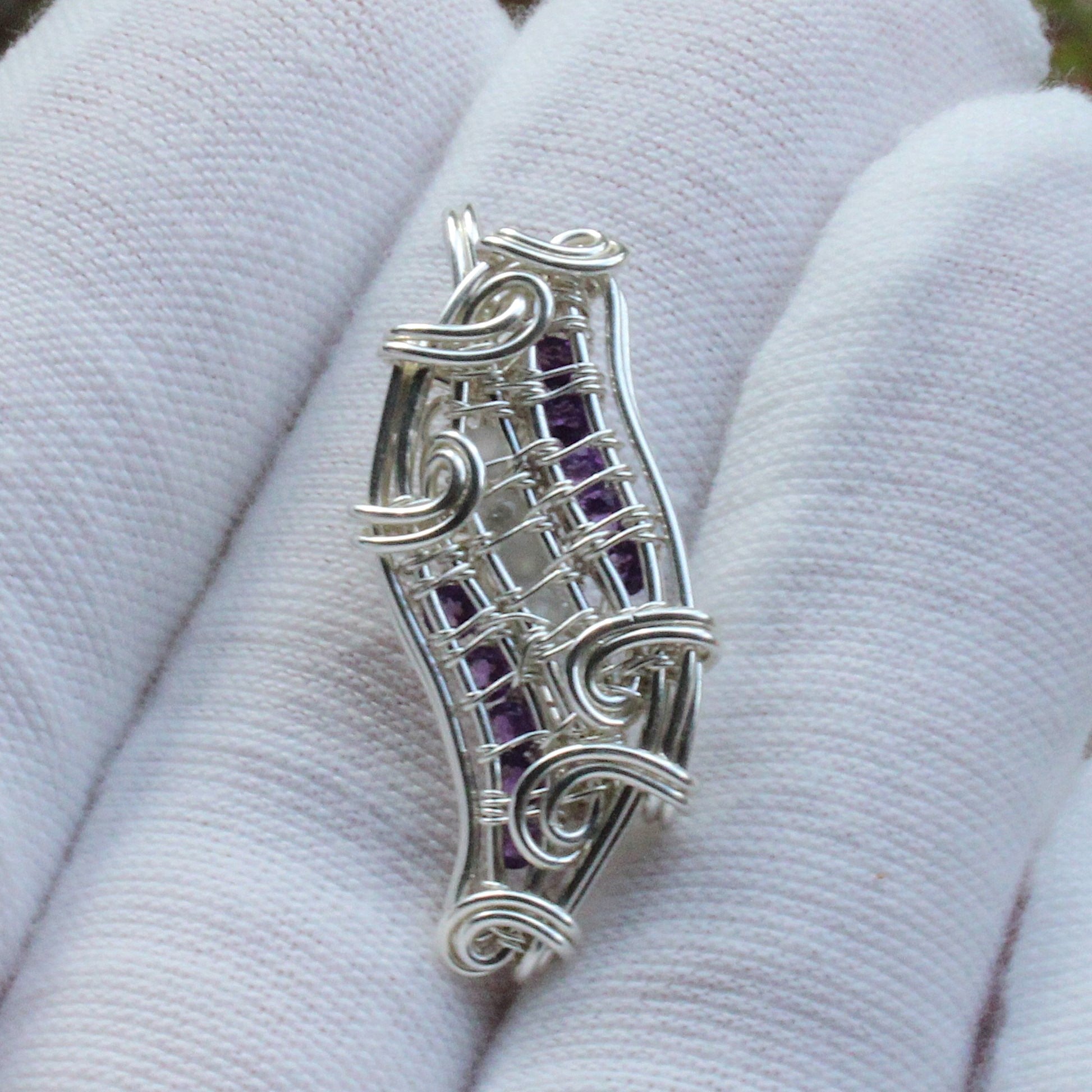 Moonstone, Amethyst, Sterling silver Pendant with intricate wire design displayed on a white glove