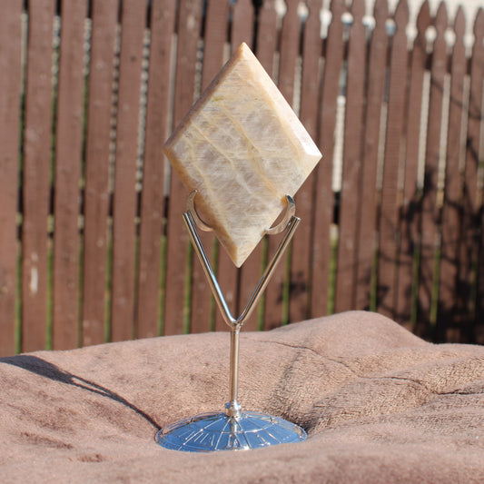 Beautiful moonstone diamond crystal displayed on a silver stand for home decor