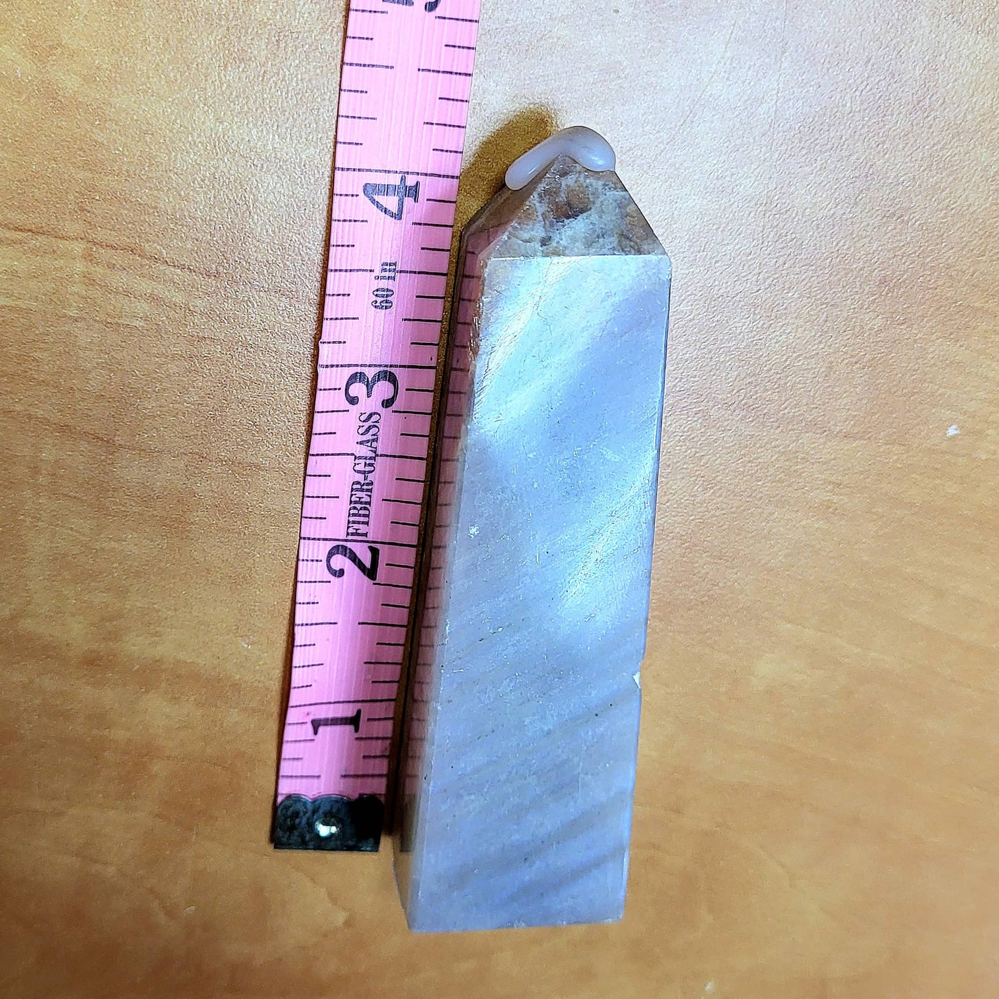 Handcrafted moonstone towers in elegant shape, showcasing shimmering blue and grey colors with height measurement