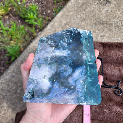 Beautiful Moss Agate Slab showcasing unique blue and green patterns in a hand-sized display