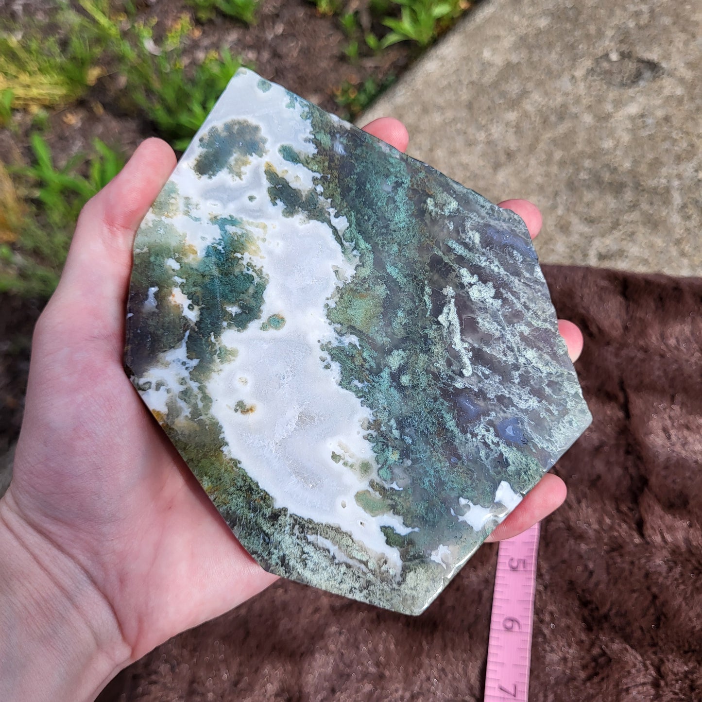 Natural Moss Agate Slab in hand, showcasing beautiful green and white patterns, perfect for gifts.
