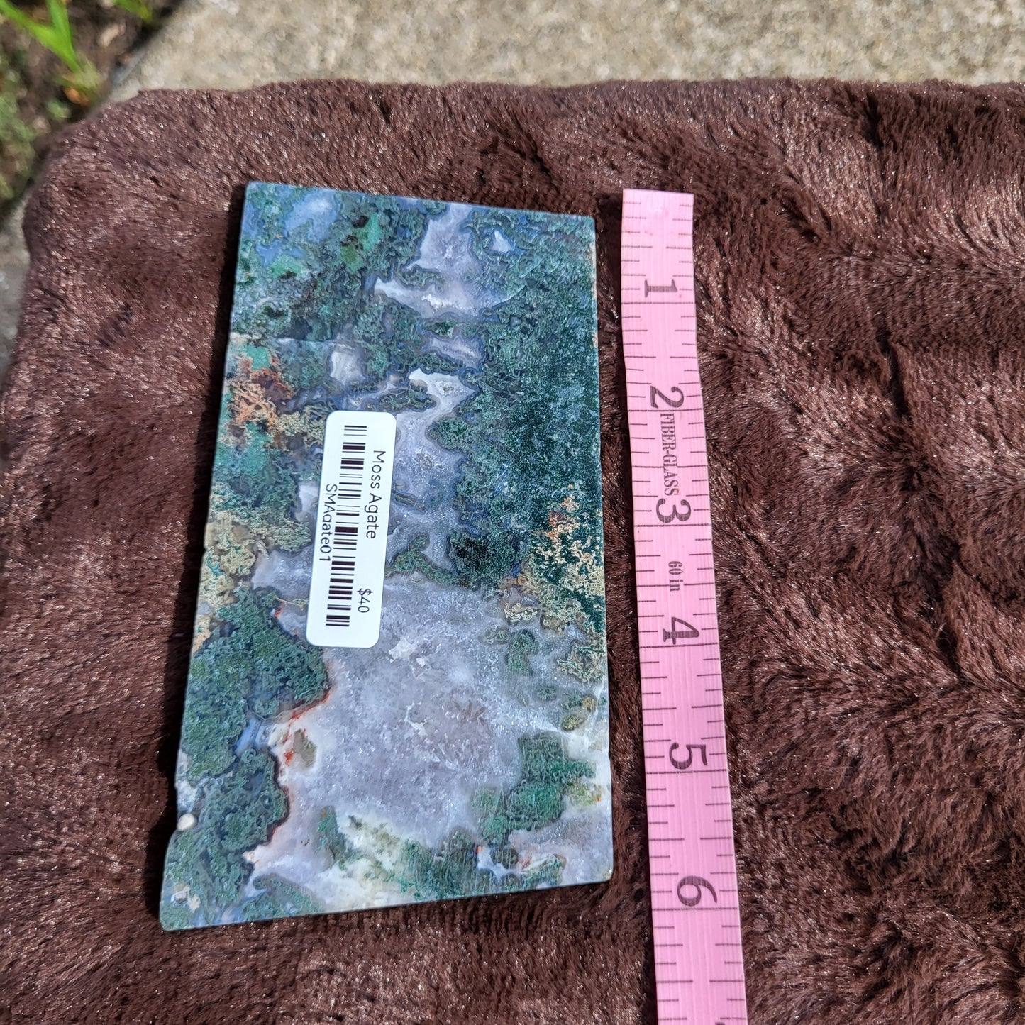 Moss Agate Slab with Unique Pattern Displayed on Plush Surface for Crystals Collection