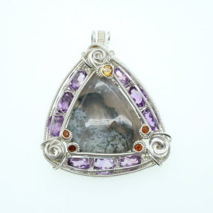 Moss agate triangular pendant framed with amethyst and citrine stones in a decorative silver setting