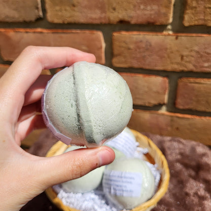 Made Natural Bath Bomb in hand, featuring Natural Color Lemon, Sweet Orange & Spearmint scents for relaxation