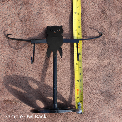 Ocean Jasper Owl Wings crystal displayed on a black metal owl rack with measuring tape showing size