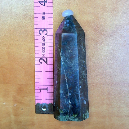 Ocean jasper tower with unique patterns displayed alongside a ruler for size reference