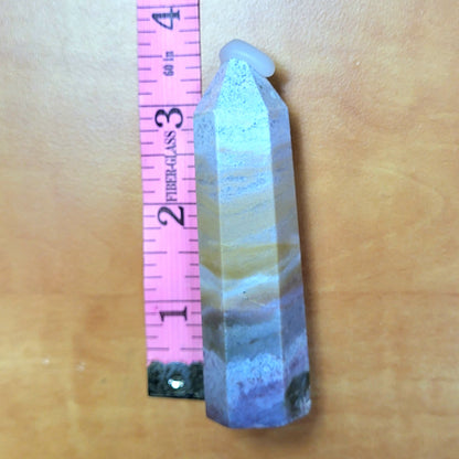 Ocean jasper tower with unique colors and patterns, measuring two inches tall for home decor