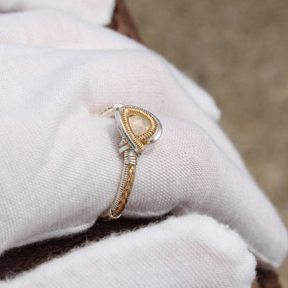 Opal Sterling ring with a delicate woven design and a sparkling opal centerpiece