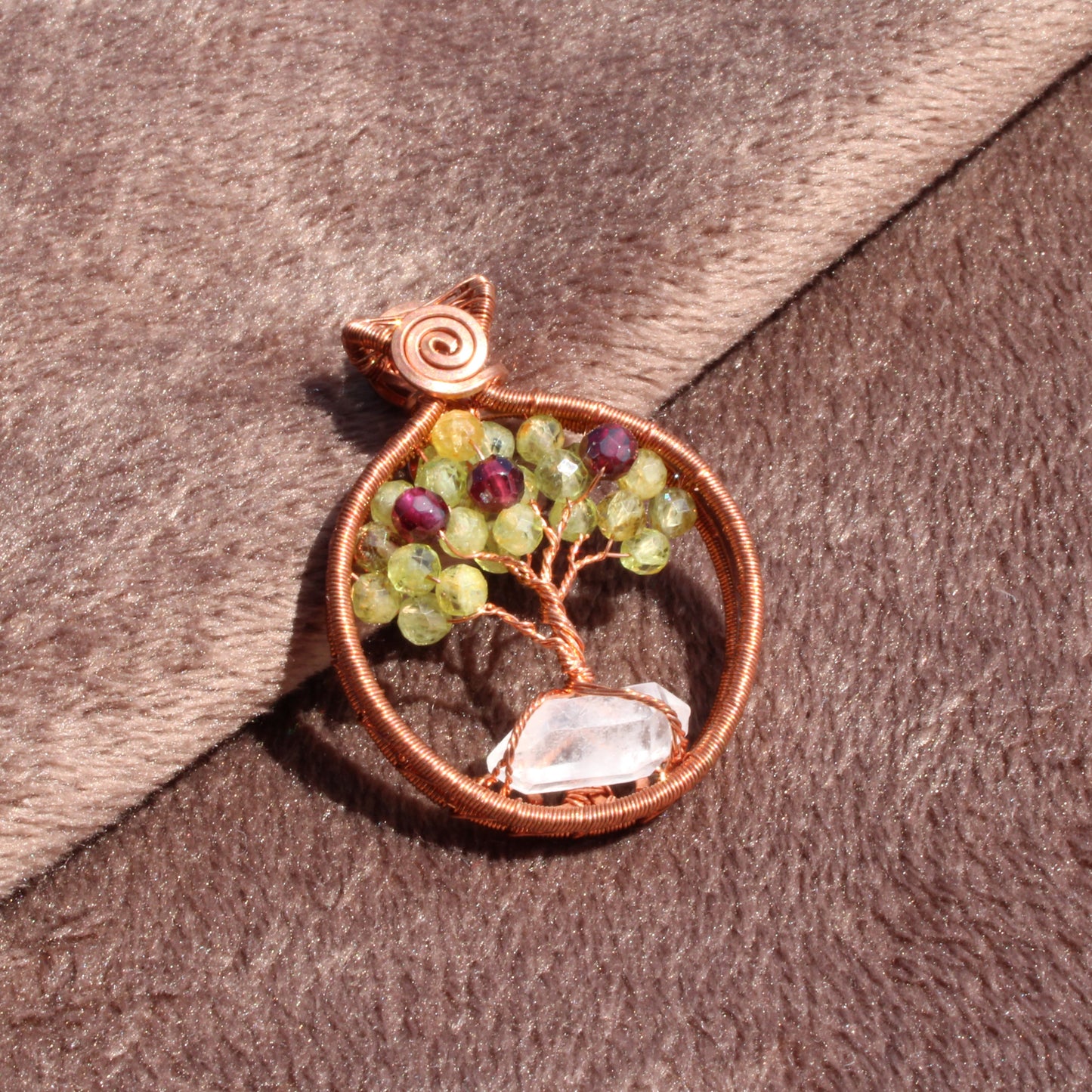 Handcrafted peridot apple tree - tree of life pendant in copper wire with a clear stone base