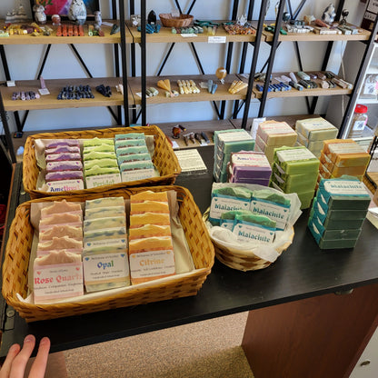 Colorful Herbal Boutique Peridot Crystal Inspired Soap | Lemon displayed in wicker baskets