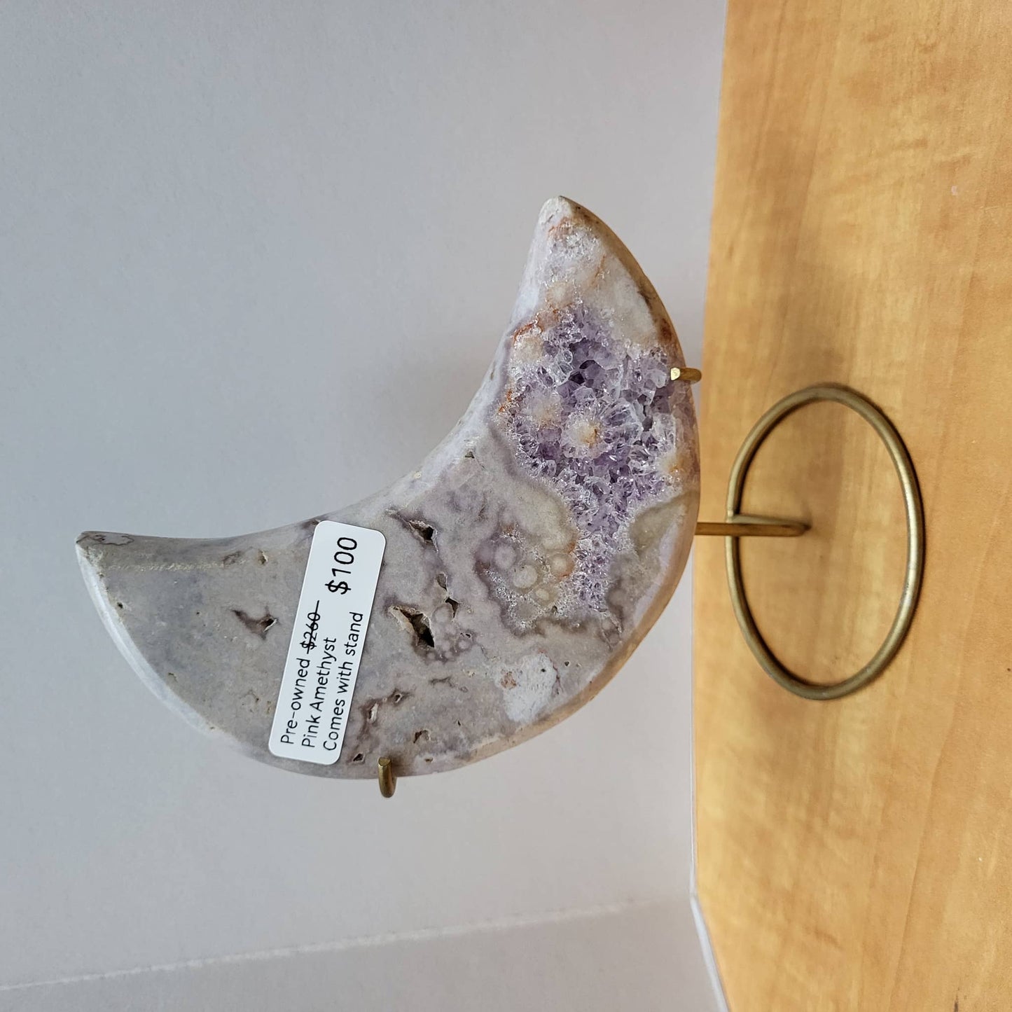 Pre-owned Pink Amethyst Moon with Stand displayed elegantly on a gold holder