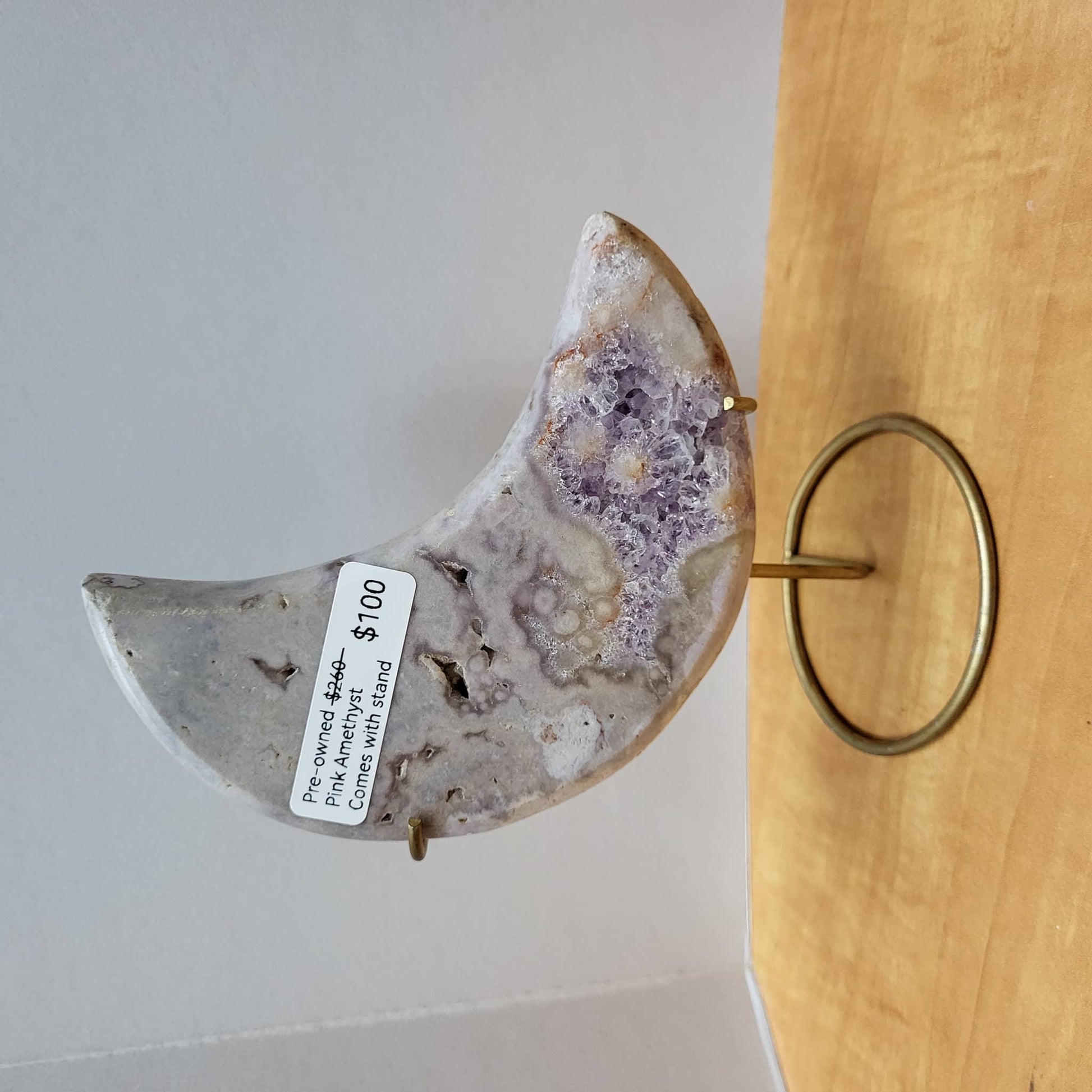 Pre-owned Pink Amethyst Moon with Stand displayed elegantly on a gold holder