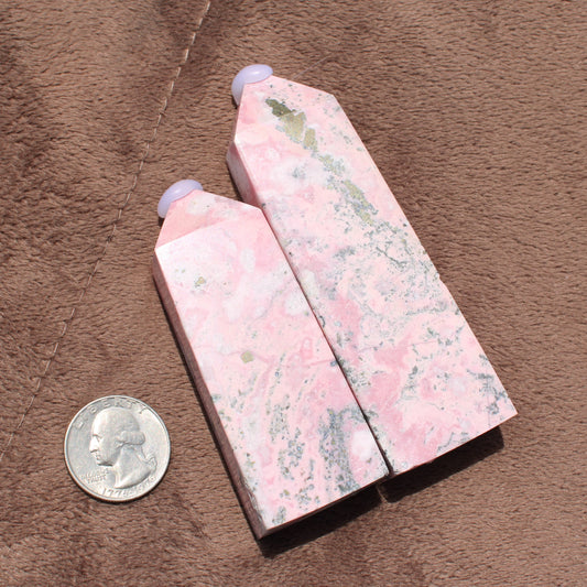 Two polished Pink Opal Tower crystals with natural white and gray patterns displayed beside a quarter for size reference