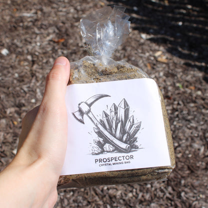 Hand holding Different Branches Prospector crystal mining bag with sand and crystal label Gem mining mystery bags