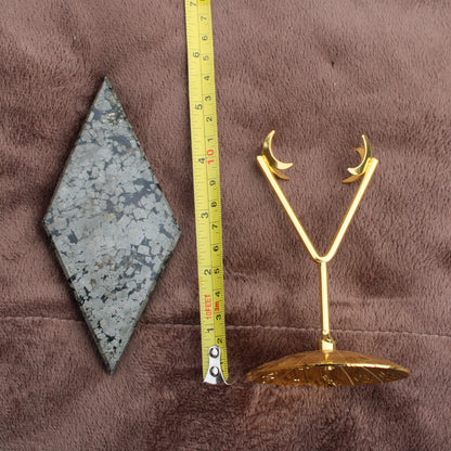 Pyrite Diamond crystal from Different Branches LLC displayed next to measuring tape and gold moon-shaped stand