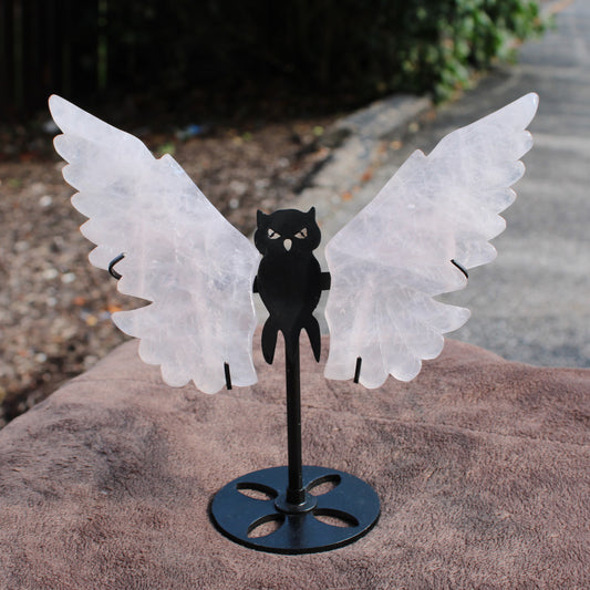 Quartz Owl Wings crystal sculpture with translucent wings mounted on a black metal stand