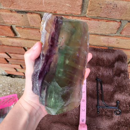 Rainbow Fluorite Slab held in hand with natural color variations showcasing unique patterns