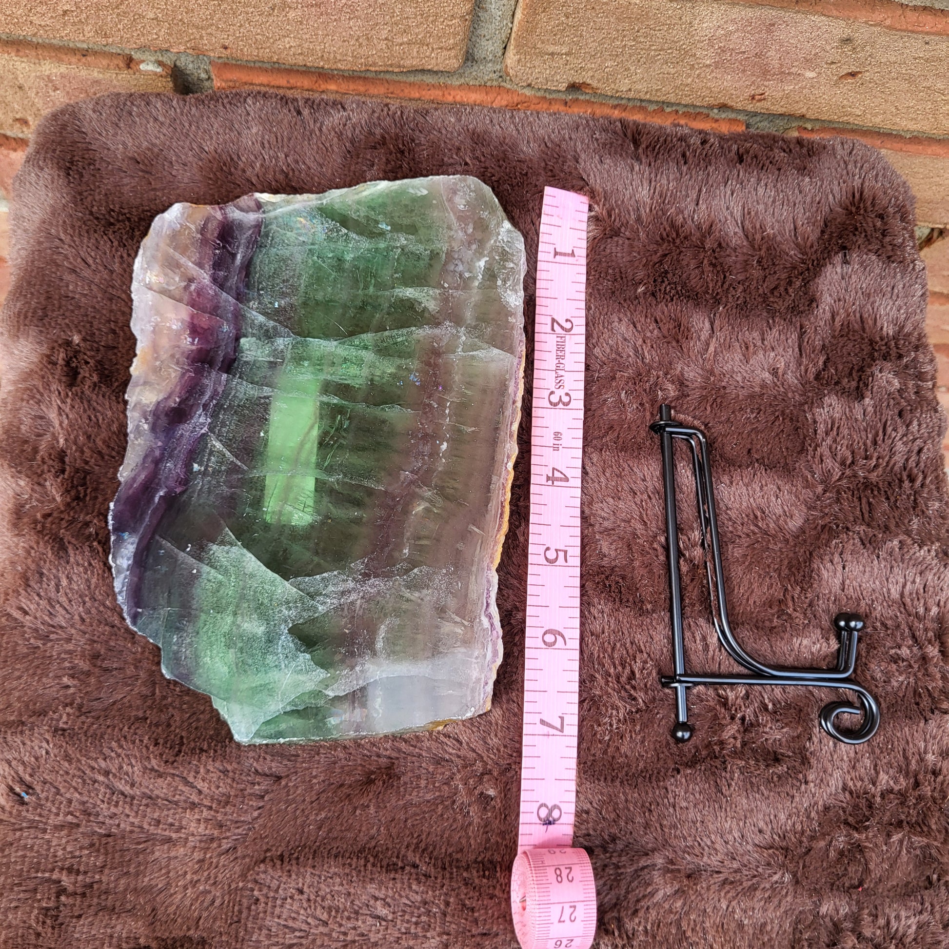Rainbow Fluorite Slab with Vibrant Green and Purple Colors, Displayed with a Measuring Tape