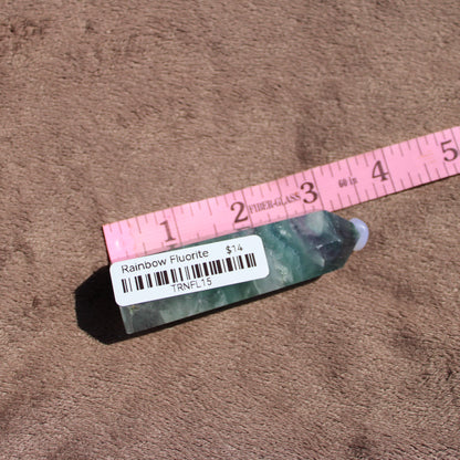 Rainbow Fluorite tower with natural green and purple hues on a soft background